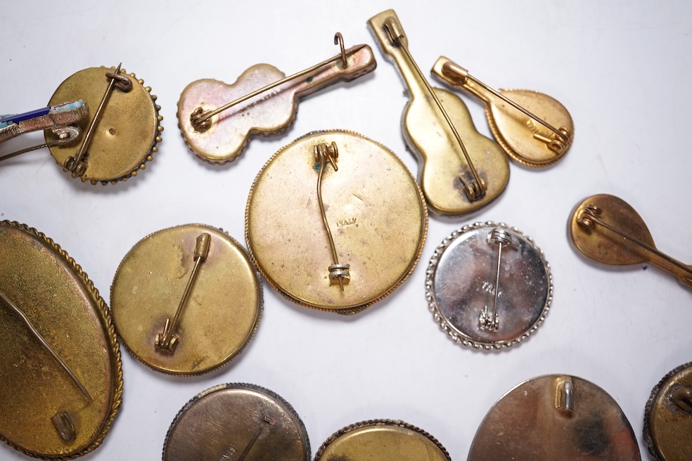 A collection of twenty-eight brooches, including fourteen mixed guitar and banjo shaped brooches, six large oval brooches, seven smaller brooches and one small oval., Condition - good